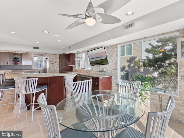 dining area with sink and ceiling fan