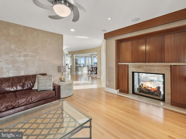 40110 Owens Ct, Fenwick Island, DE 19944 - living area featuring baseboards, recessed lighting, light wood-style flooring, a multi sided fireplace, and ceiling fan