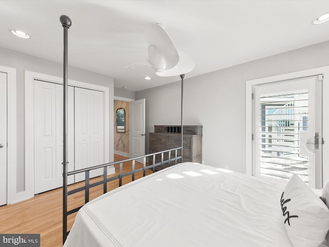 bedroom with a closet, hardwood / wood-style flooring, and ceiling fan