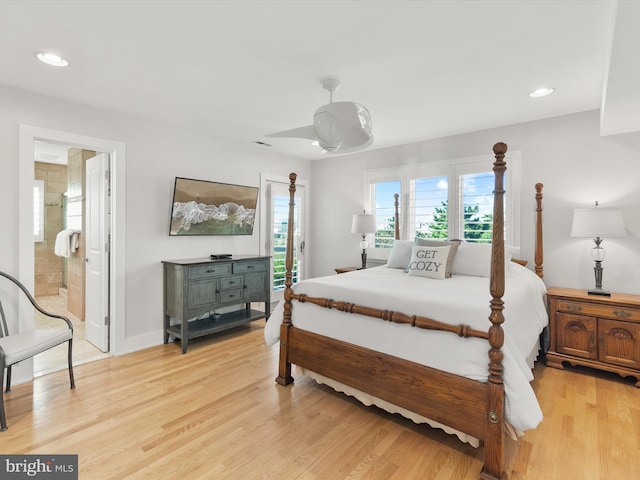 bedroom featuring ceiling fan, light hardwood / wood-style floors, and ensuite bath