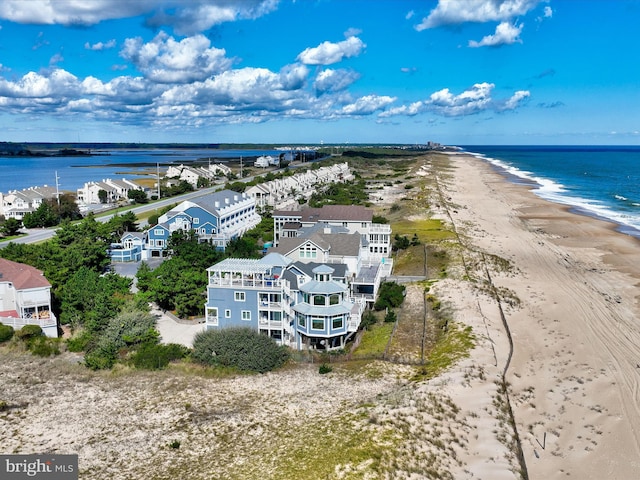 birds eye view of property with a beach view and a water view