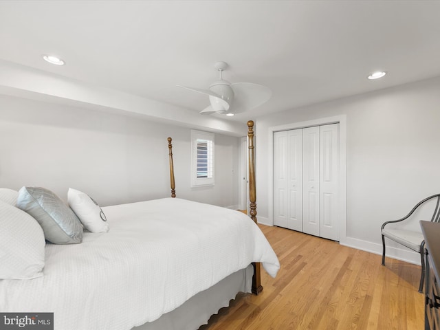 bedroom featuring ceiling fan, a closet, and light hardwood / wood-style floors