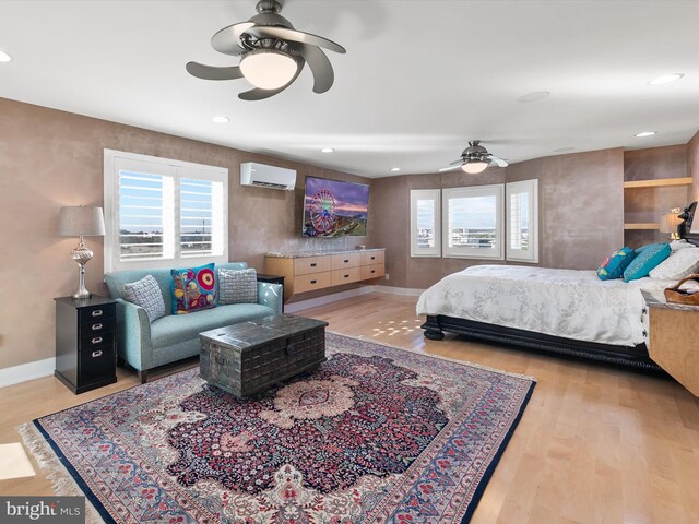 40110 Owens Ct, Fenwick Island, DE 19944 - bedroom featuring a ceiling fan, multiple windows, wood finished floors, and a wall mounted air conditioner