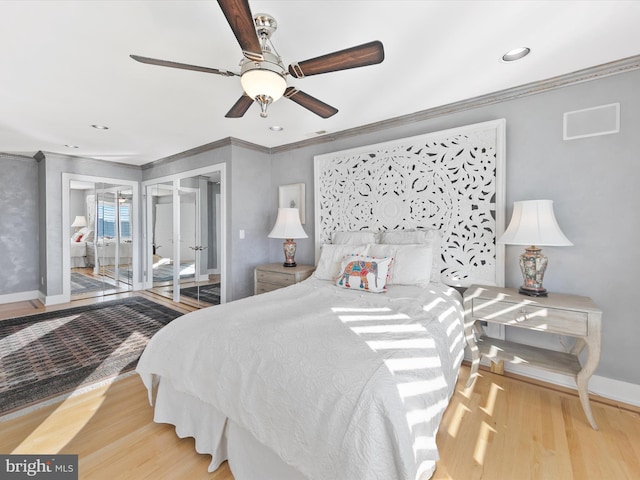 bedroom with crown molding, ceiling fan, and light hardwood / wood-style flooring