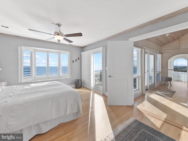 bedroom featuring a water view, multiple windows, ceiling fan, and light wood-type flooring