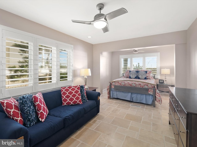 bedroom with multiple windows and ceiling fan