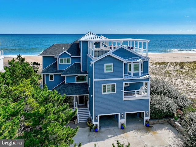 exterior space with a water view and a view of the beach