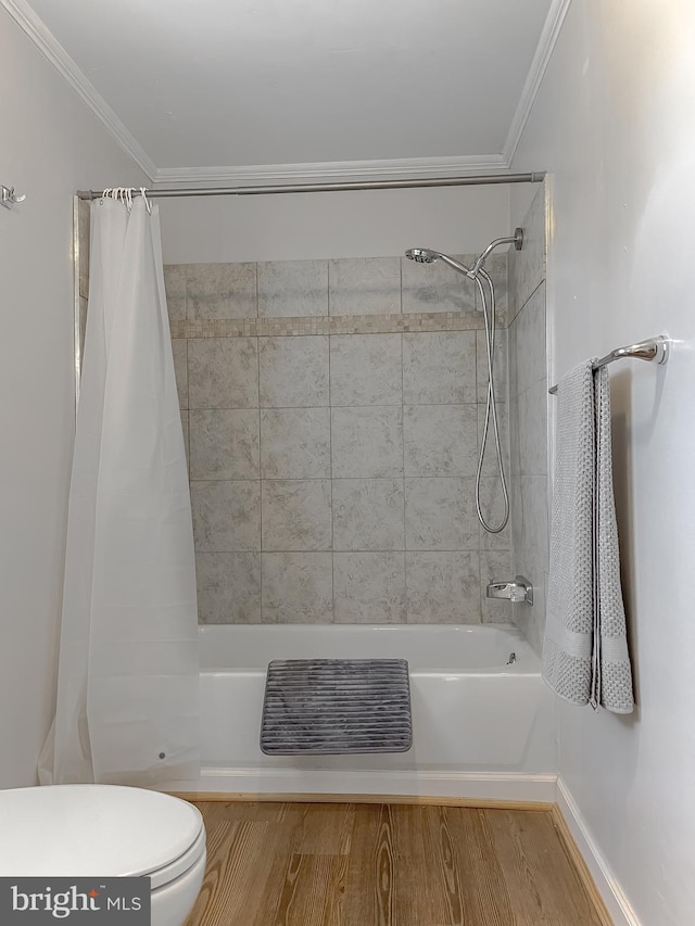 bathroom with crown molding, toilet, hardwood / wood-style flooring, and shower / bath combo