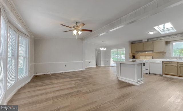 kitchen with light hardwood / wood-style floors, a healthy amount of sunlight, a center island, and white appliances