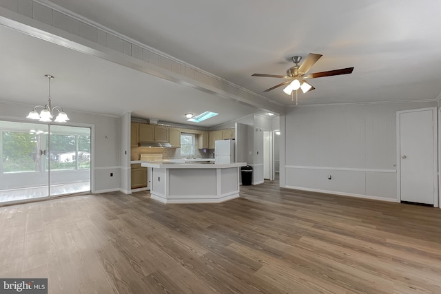 kitchen with tasteful backsplash, hardwood / wood-style flooring, ornamental molding, a center island, and white refrigerator