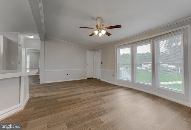 spare room featuring ornamental molding, wood-type flooring, and ceiling fan