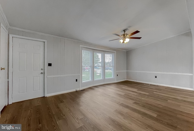 interior space with crown molding, wood-type flooring, and ceiling fan