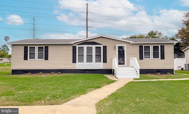 manufactured / mobile home with central air condition unit and a front yard