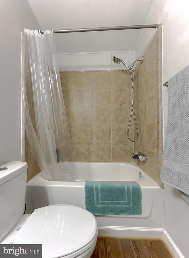 bathroom with toilet, hardwood / wood-style flooring, and shower / bath combination with curtain