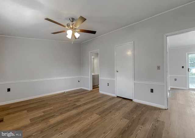 unfurnished bedroom featuring ornamental molding, hardwood / wood-style floors, connected bathroom, and ceiling fan