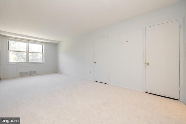 empty room featuring light colored carpet