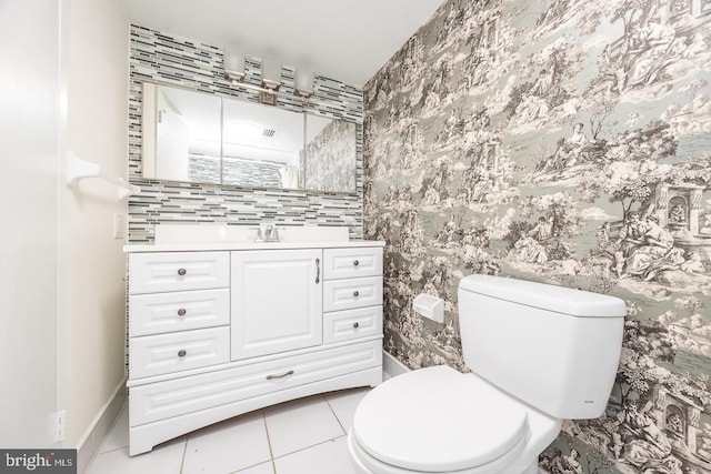 bathroom with vanity, toilet, and tile patterned floors