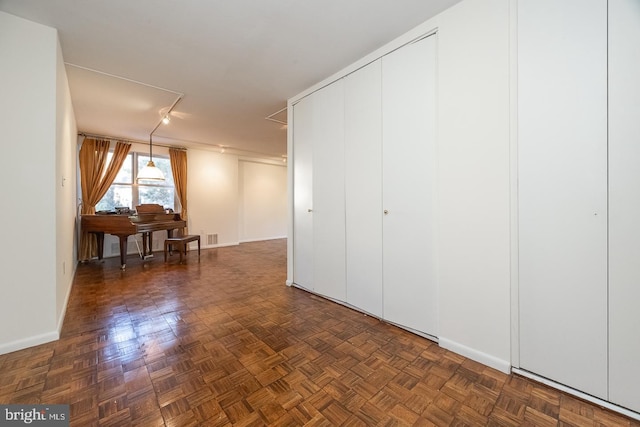 basement featuring dark parquet flooring