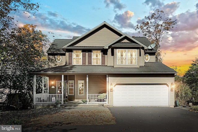 view of front of property featuring a porch and a garage