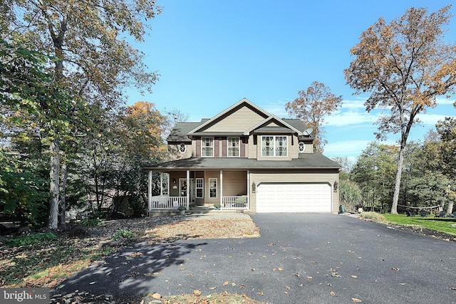 view of front of property featuring a garage and a porch