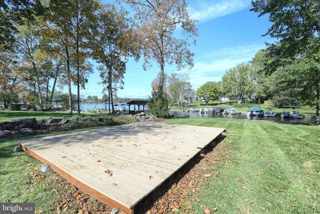 surrounding community featuring a water view and a yard