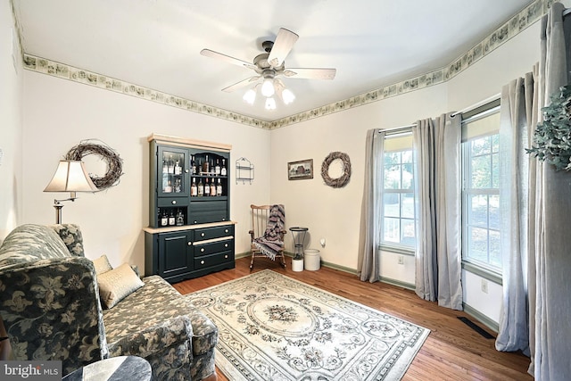 living room featuring hardwood / wood-style flooring and ceiling fan