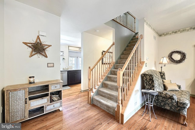 stairway with hardwood / wood-style flooring