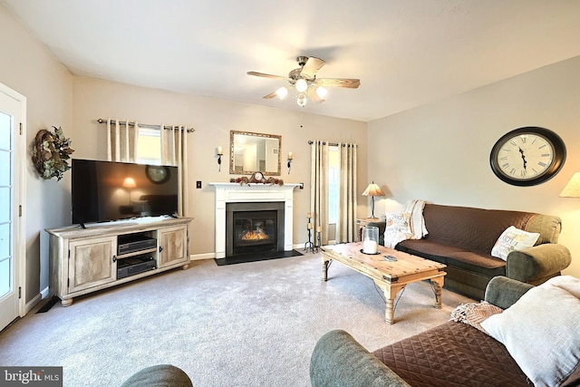 carpeted living room with ceiling fan