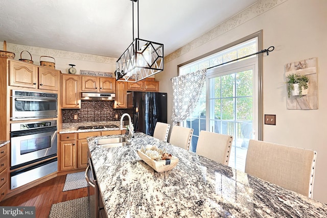 dining area featuring dark wood-type flooring and sink