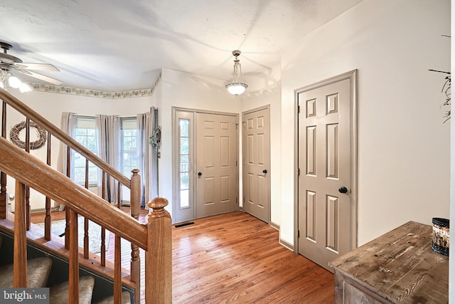 entrance foyer featuring ceiling fan and light hardwood / wood-style floors