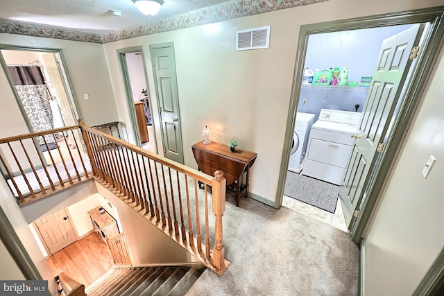 staircase featuring carpet flooring and washing machine and dryer