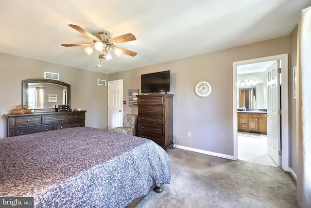 carpeted bedroom featuring ensuite bath and ceiling fan