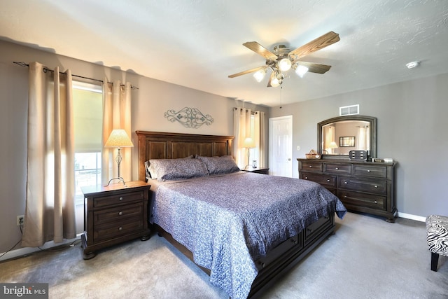 bedroom featuring light carpet and ceiling fan