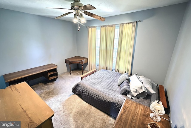 bedroom with dark colored carpet and ceiling fan