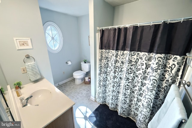 bathroom featuring walk in shower, vanity, and toilet