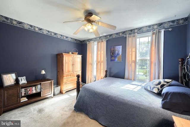 bedroom featuring ceiling fan and light colored carpet