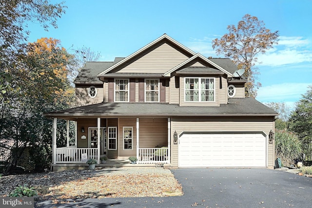 view of front of home featuring covered porch and a garage