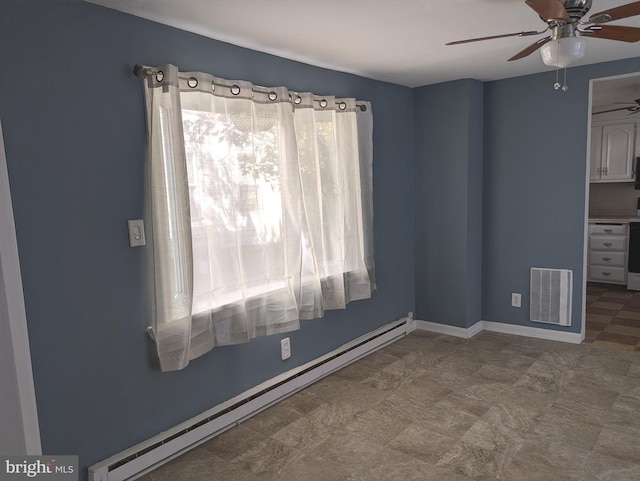 spare room with a baseboard heating unit, baseboards, visible vents, and a ceiling fan