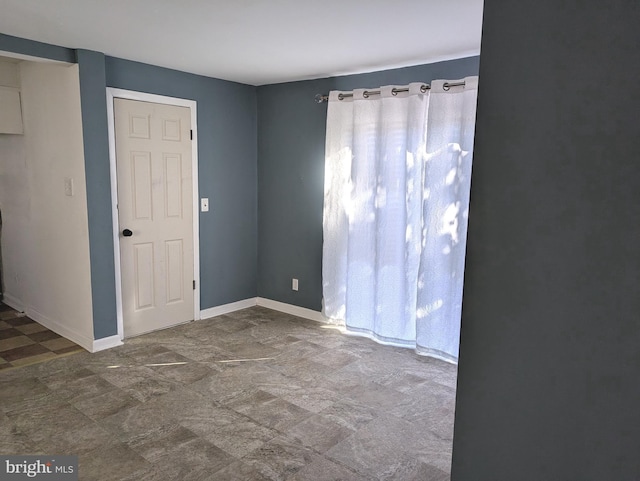 empty room with baseboards