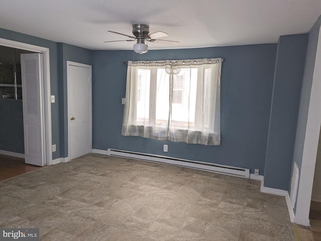 unfurnished bedroom featuring a baseboard heating unit and ceiling fan