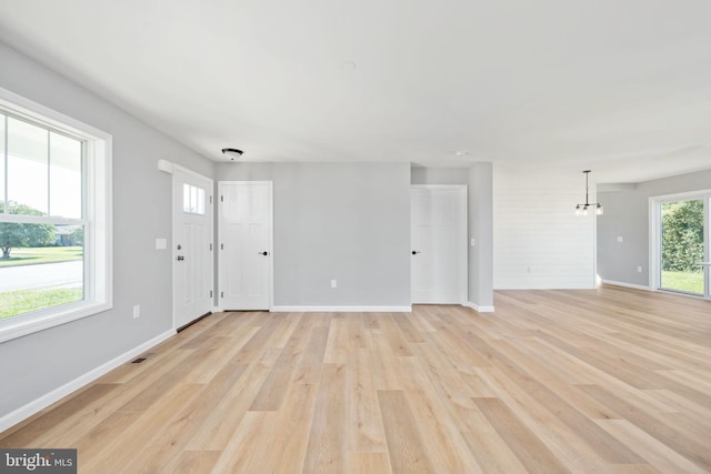 interior space with an inviting chandelier and light wood-type flooring