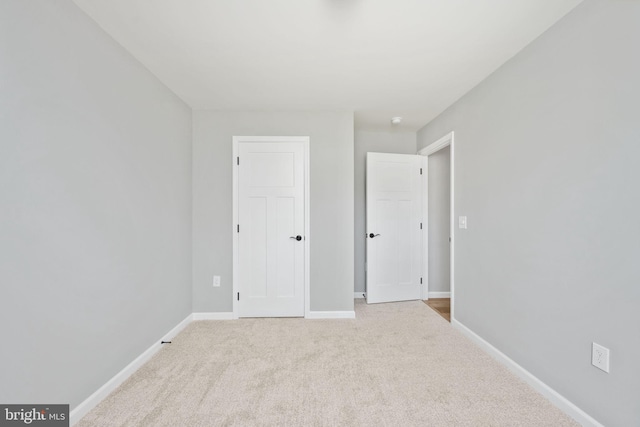 unfurnished bedroom featuring light carpet