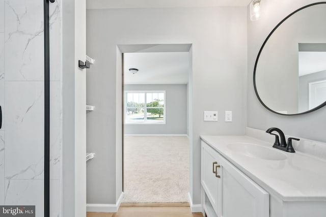 bathroom with hardwood / wood-style floors and vanity