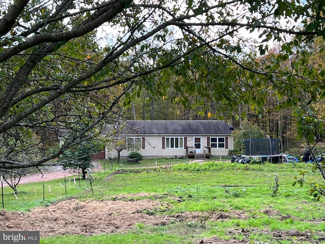 ranch-style house with a trampoline