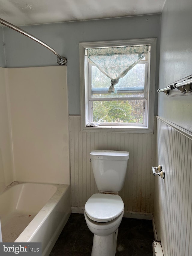 bathroom with toilet and wooden walls