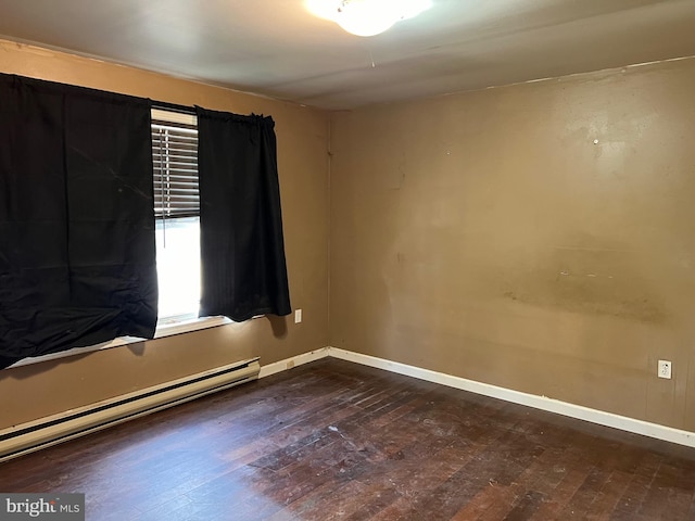 empty room featuring a baseboard radiator and dark wood-type flooring