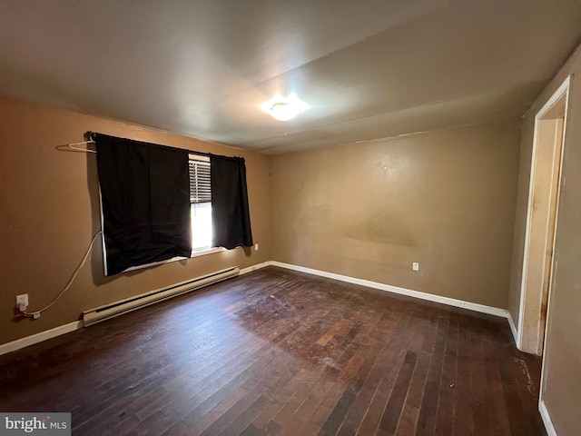 spare room with a baseboard radiator and dark wood-type flooring