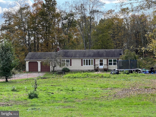 view of front facade with a garage and a trampoline