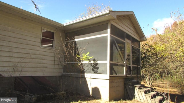 view of property exterior featuring a sunroom