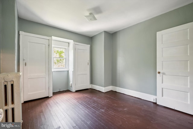 unfurnished bedroom featuring dark wood-type flooring